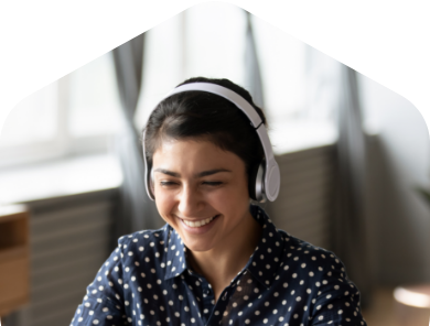 A woman wearing headphones and smiling for the camera.