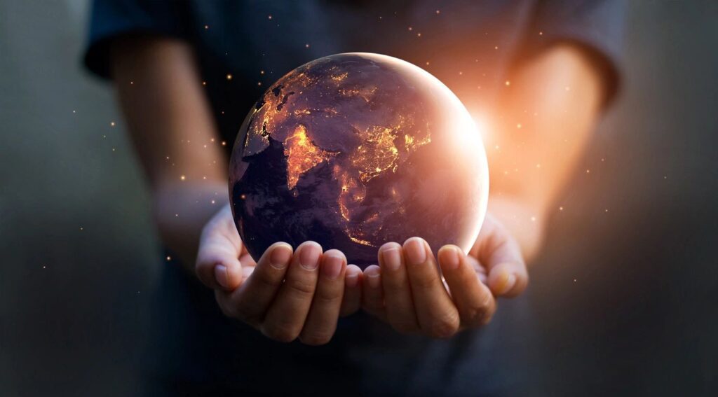 A person holding an earth globe in their hands.